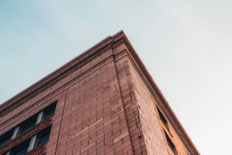 a brick building is shown against a clear blue sky