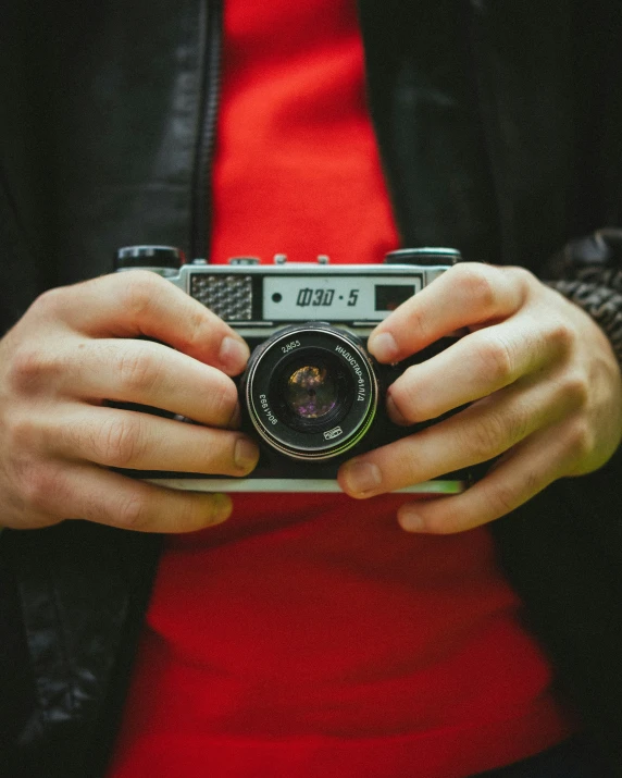 a person with their hands around a camera