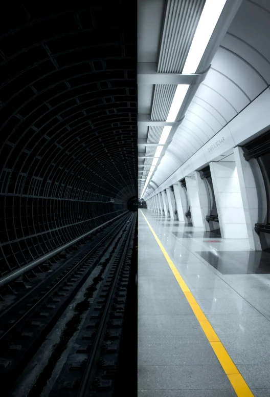 the subway is coming into a tunnel at the end of it