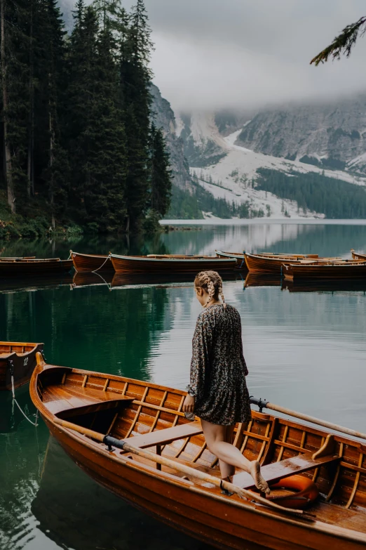 a person in the bow of a canoe on a body of water