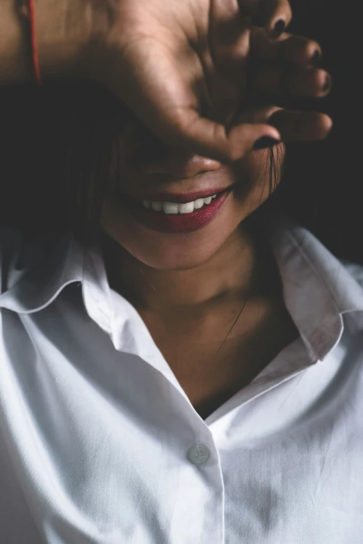 the woman smiles brightly while posing for a po