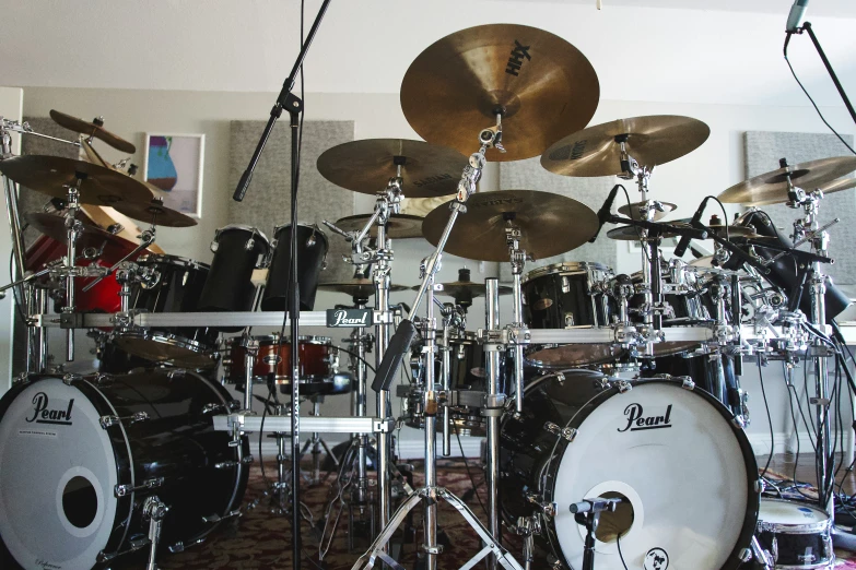 a drum set sits on the floor in a home music studio