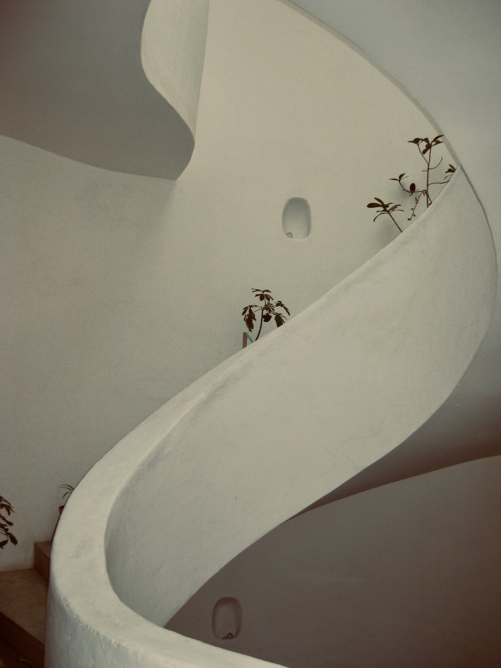 a very tall white staircase inside a building
