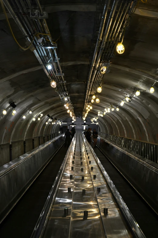 this is an underground station with several escalators