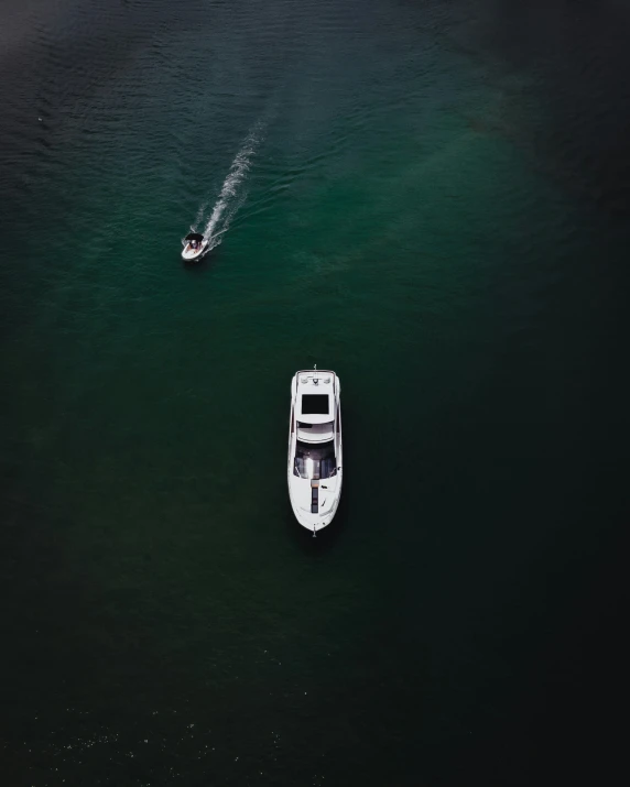 two boats and one motorboat are seen from above