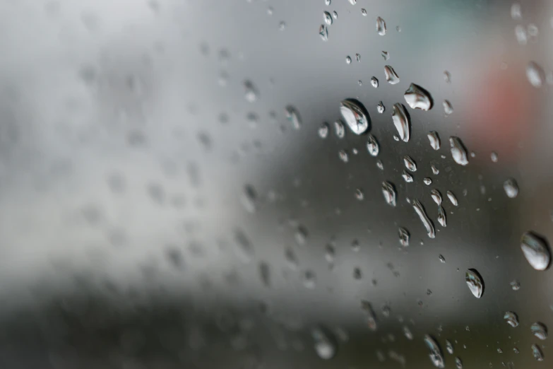 the window is covered with rain on the glass