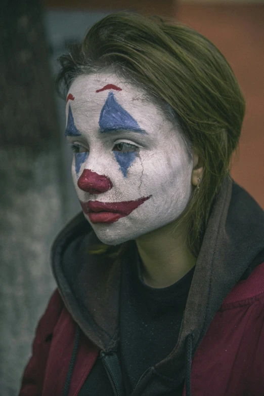 a woman with red and white painted face