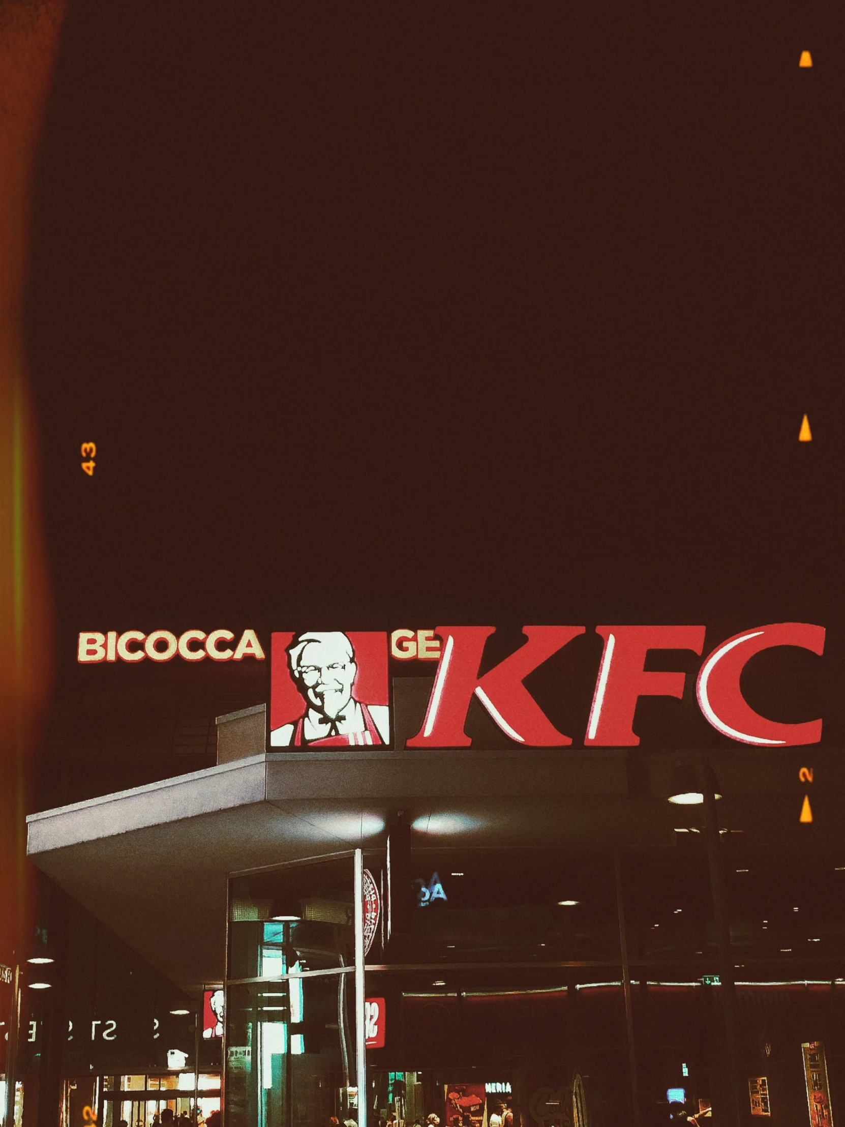 the front of a grocery store at night