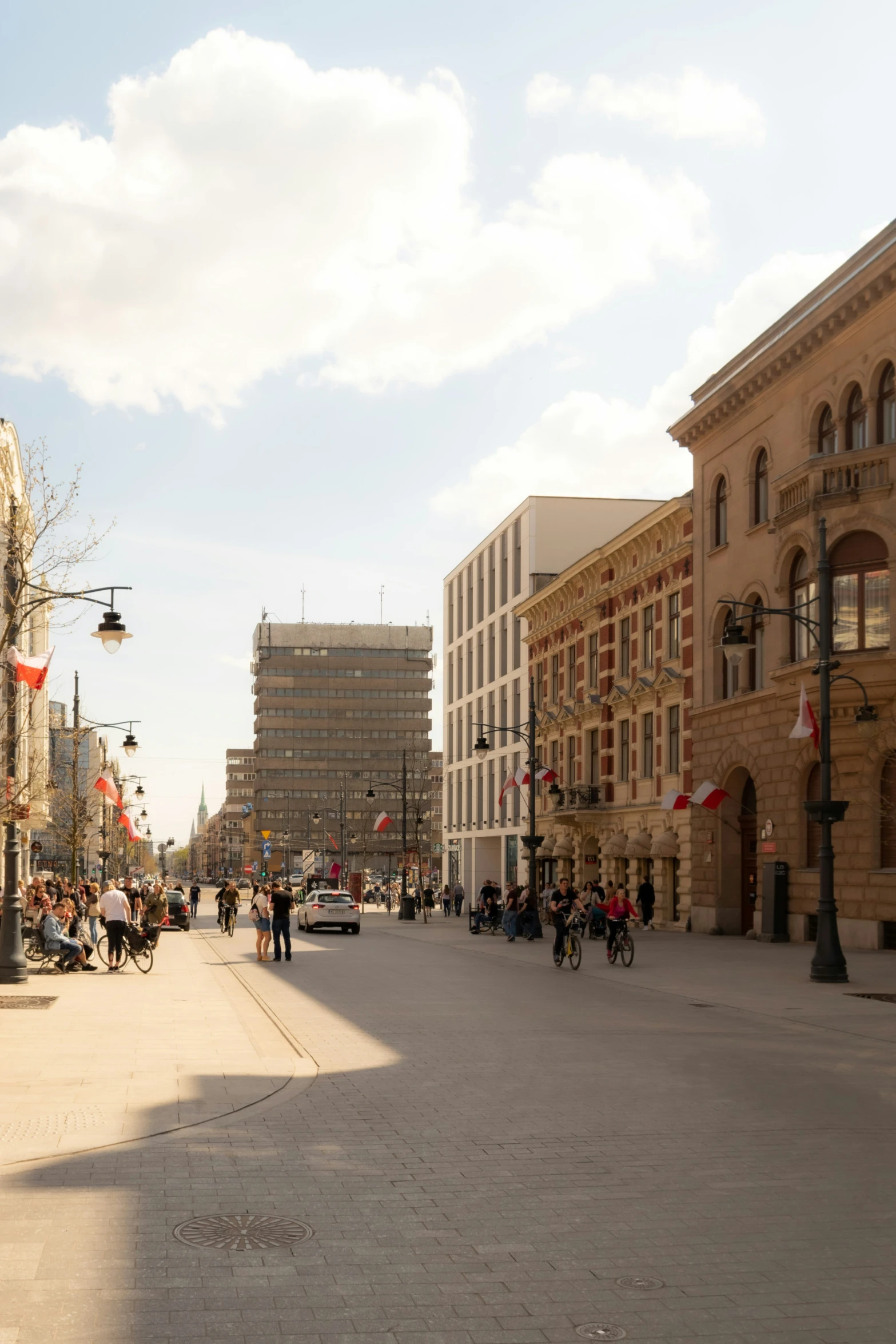 a view of people walking down a city street