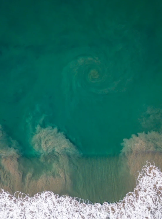 a large body of water with waves near by