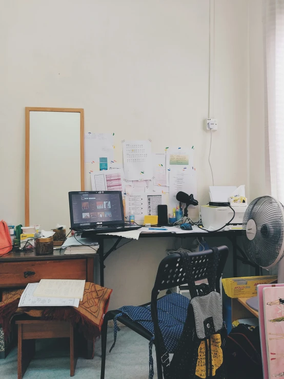 an office with some cluttered desks and other items on the table