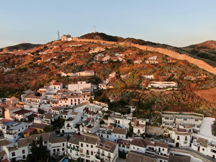 some hills a house and some houses and trees