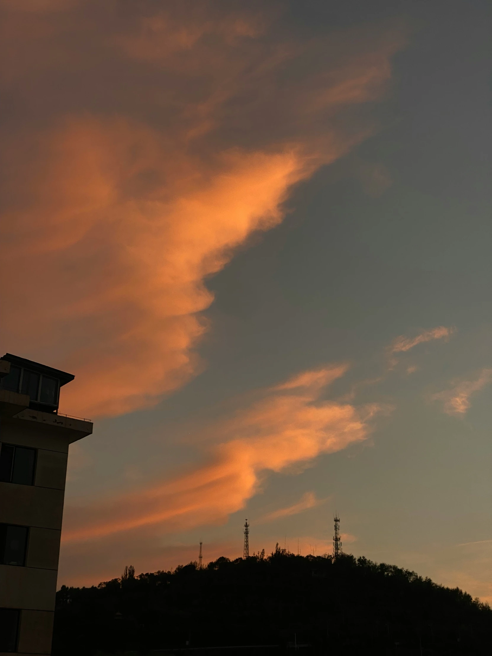 a clock tower with pink clouds in the background