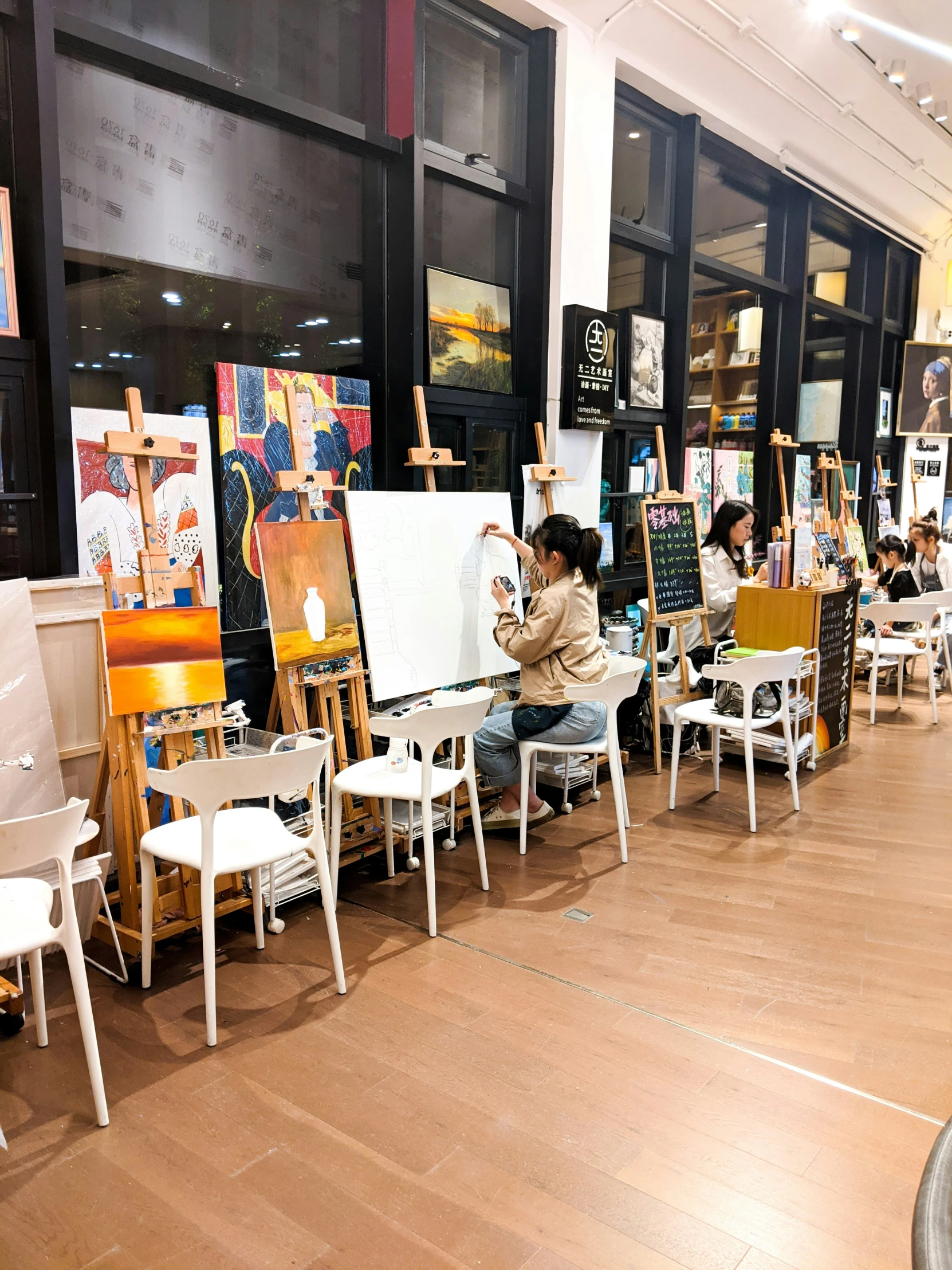 a room filled with lots of chairs and paintings