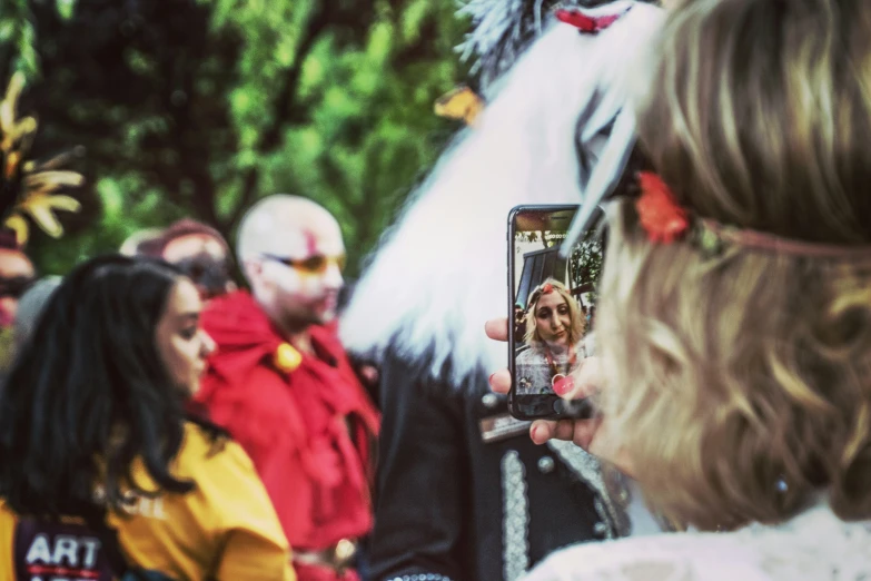 a crowd is taking pictures of a lady