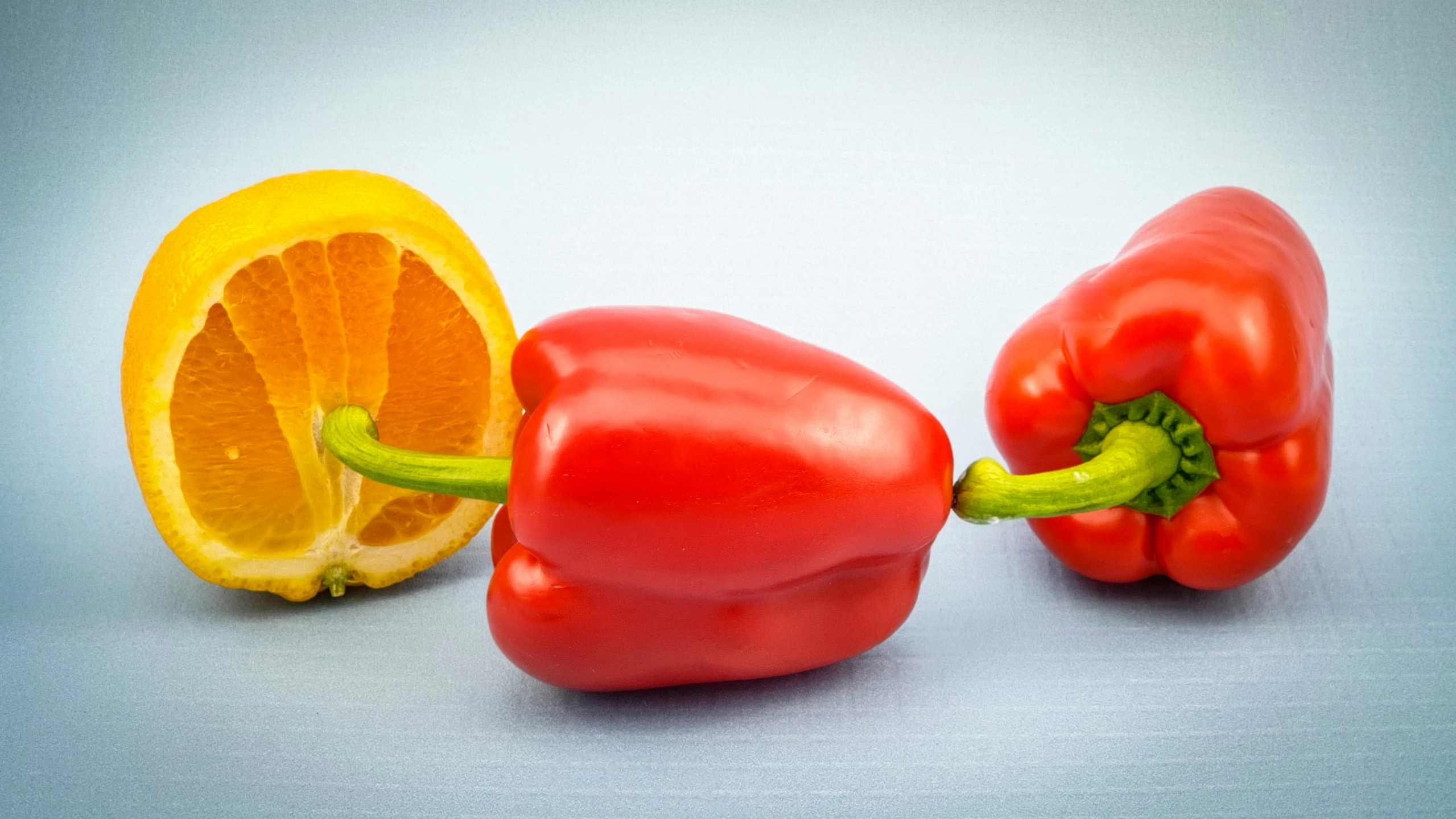 two bell peppers, one red and one orange