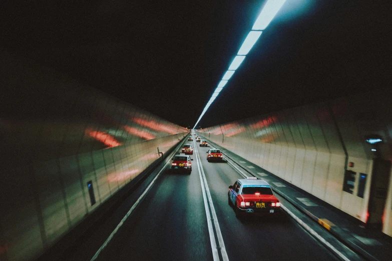 a long tunnel with lots of traffic and no one in sight