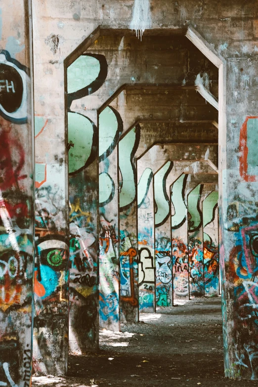 graffiti on the concrete wall and ceiling of an old cement building