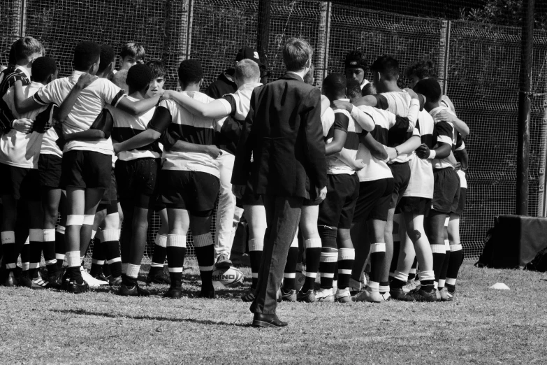 a soccer team with coach at the end of a game