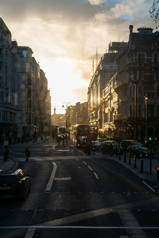 a city street with buildings and traffic at dusk