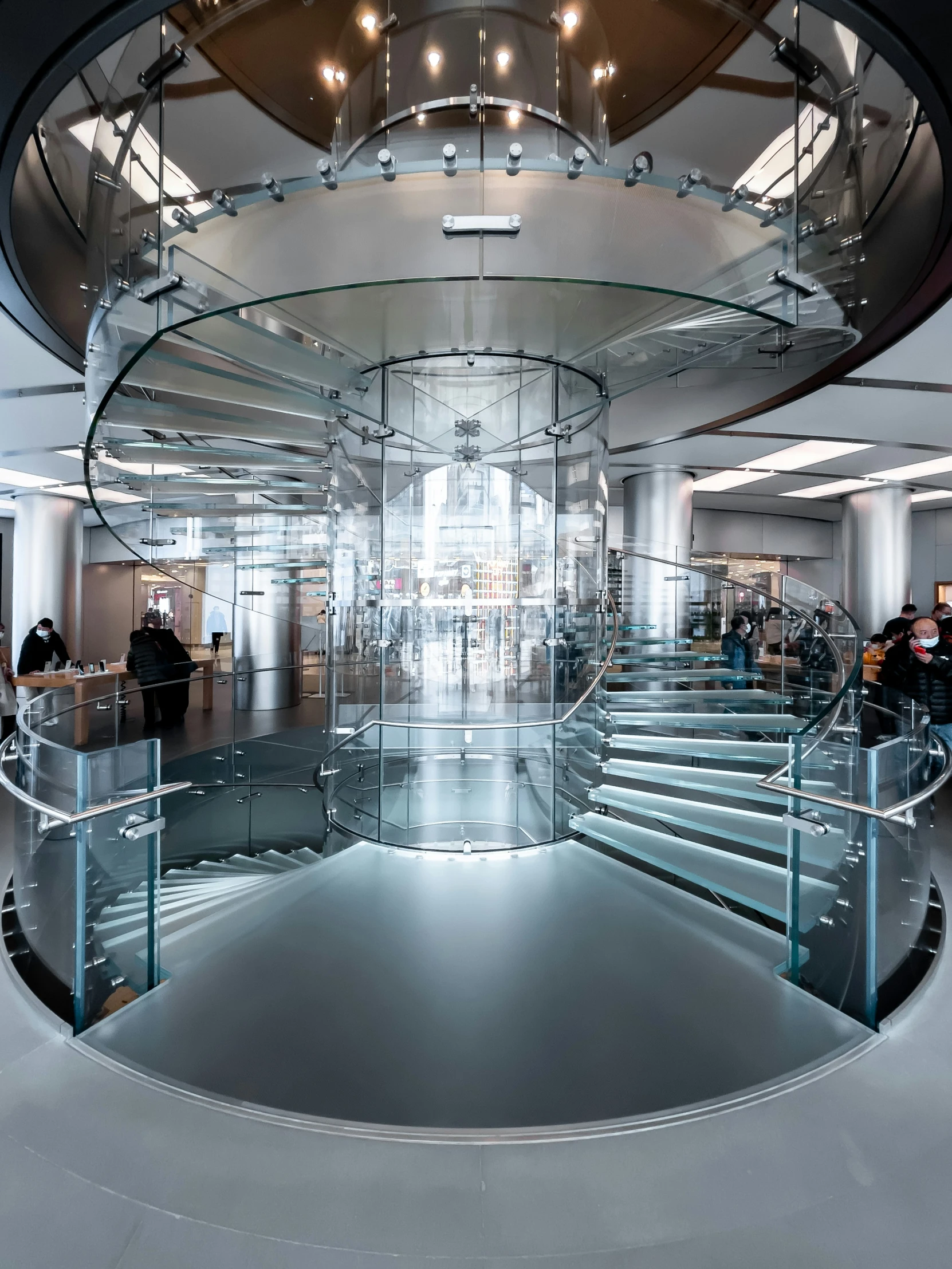 an empty stairway is seen inside a glass structure