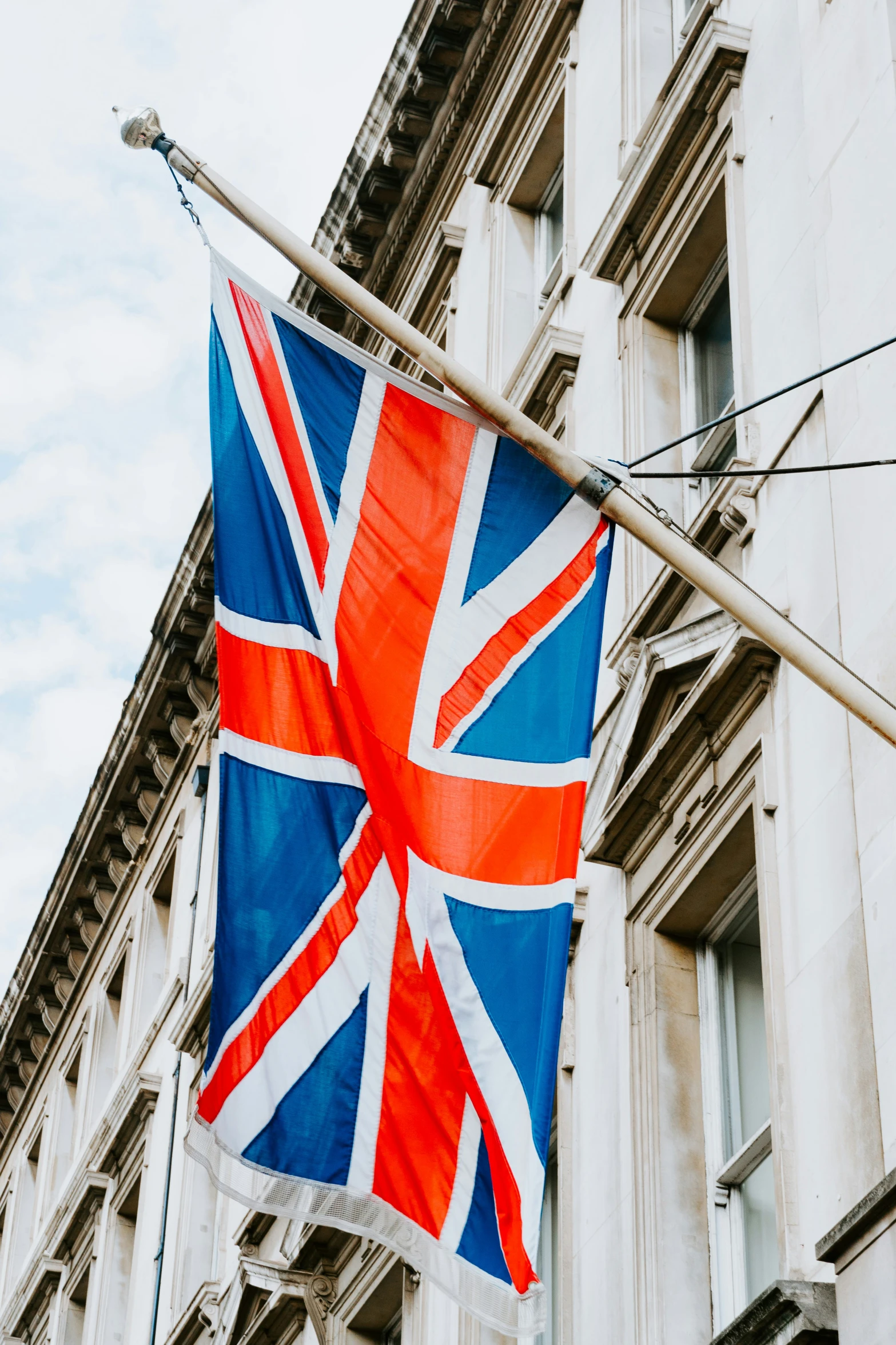 the union jack flag is hanging from a building