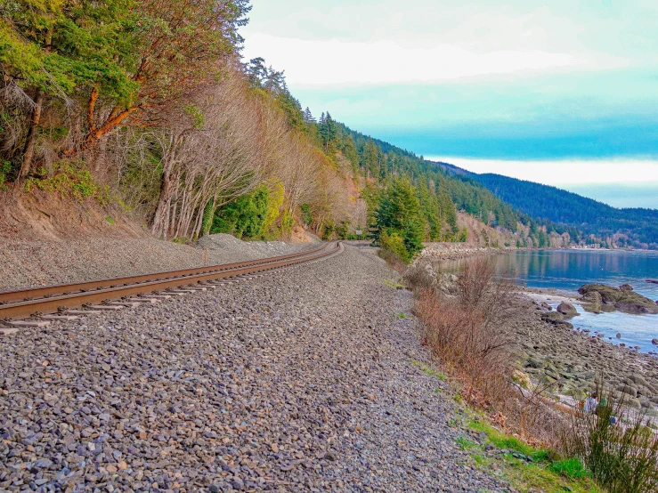 a train is going along the tracks on a steep mountain side