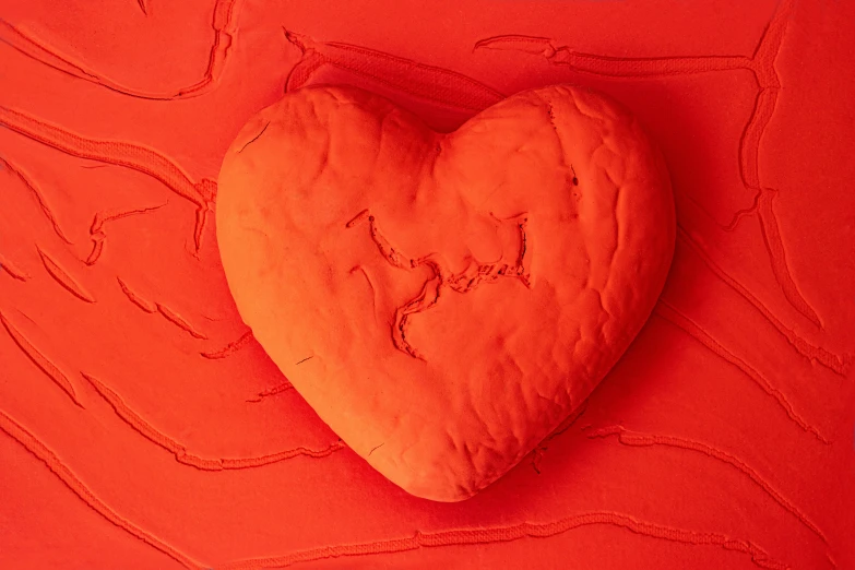 heart - shaped cookie over red backdrop for use in love