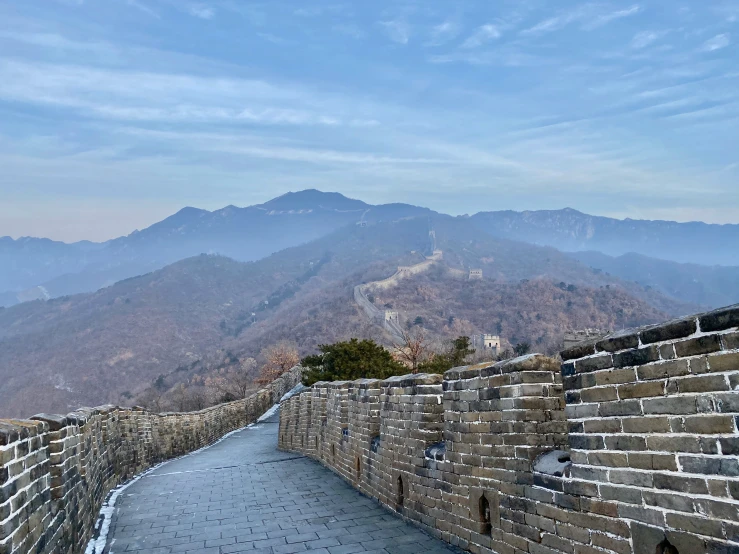 the path leading to great wall, with mountains in background