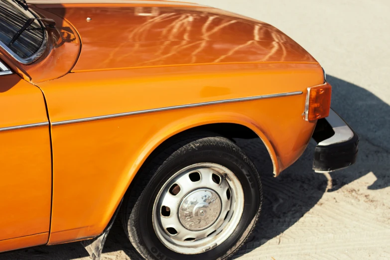 an orange car parked in front of a building