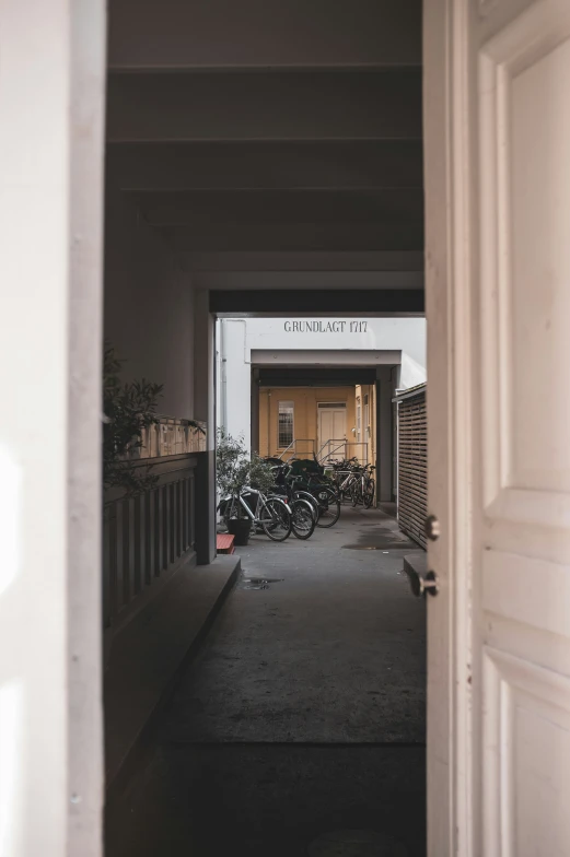 bicycles sitting out in an open door of a building