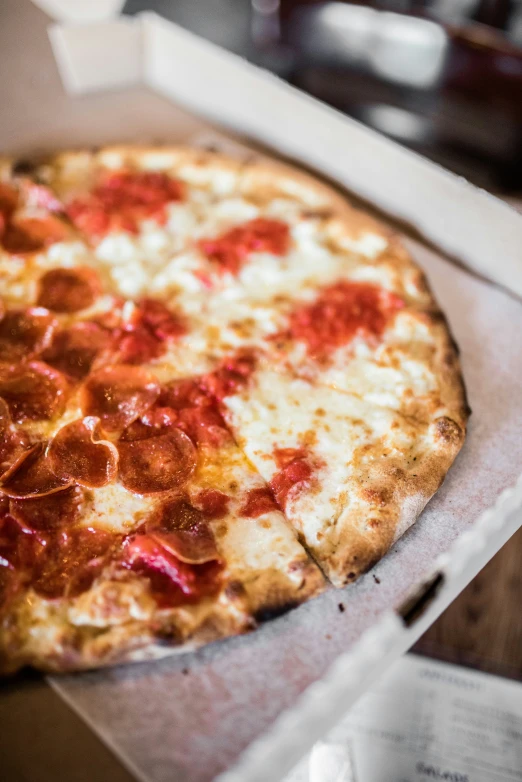 a close up of a pepperoni pizza in a box