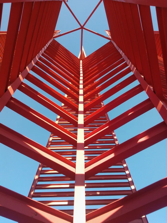 an abstract po of red pillars and blue sky