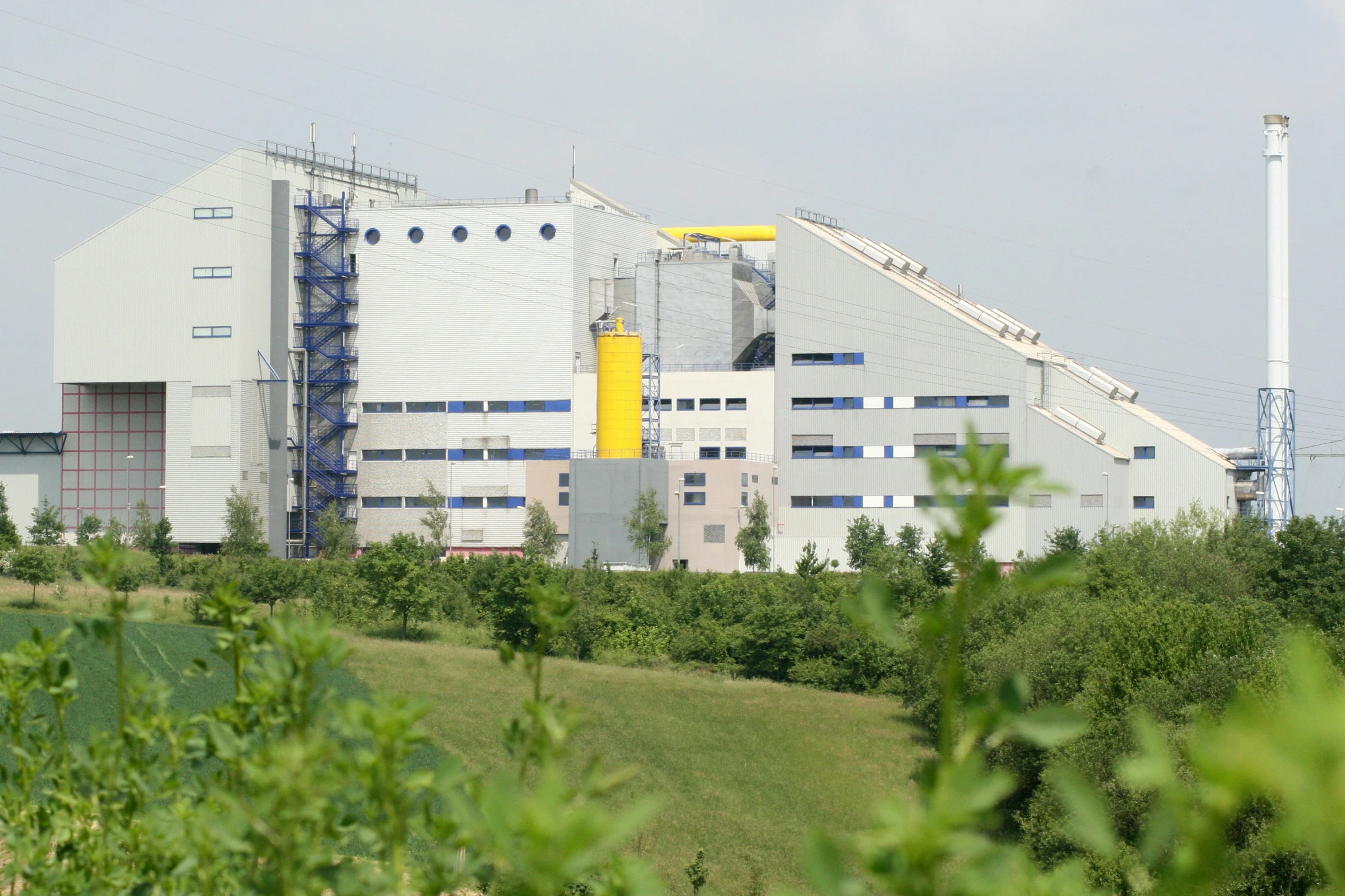 an old industrial plant sits near a grassy area