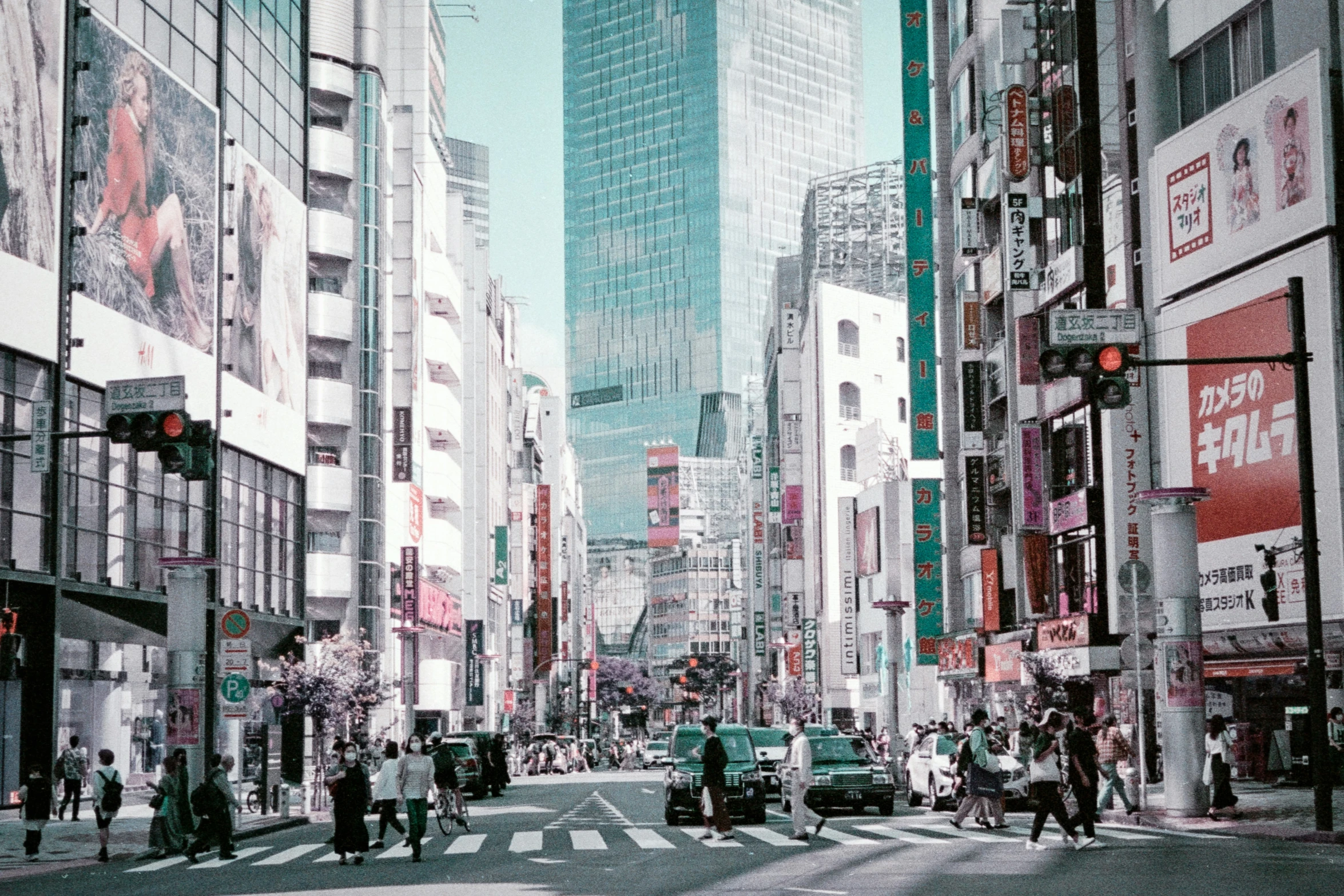 a cityscape of a busy street with traffic and pedestrians