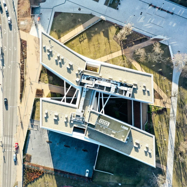 an overhead view of a large building near the highway