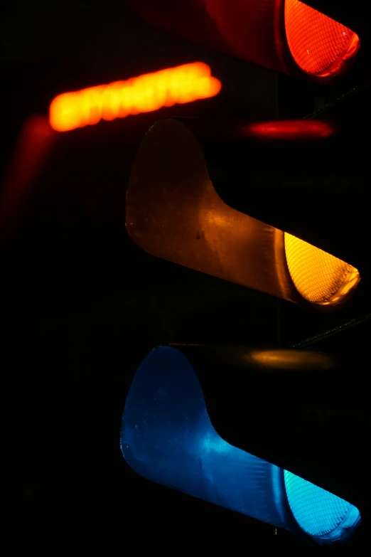 a close up of two stoplights at night