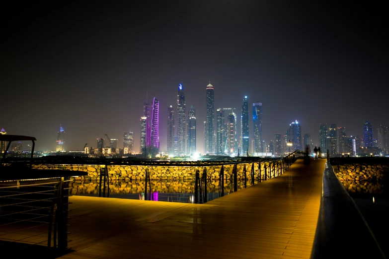 a walk way leading to a city with tall buildings