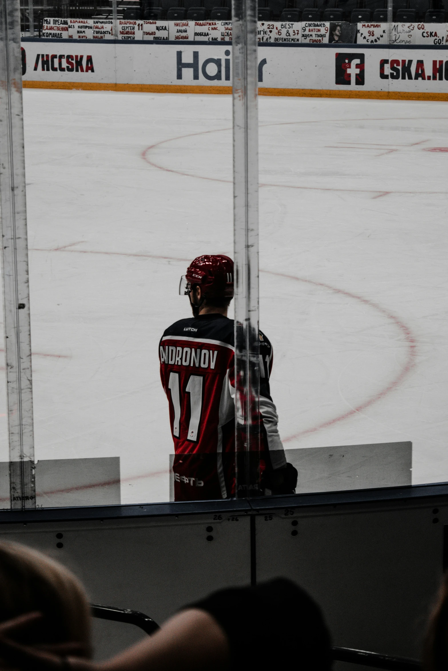 the hockey player looks out the window at the rink