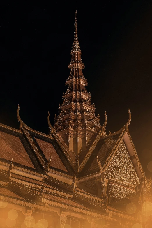 a tall building with an intricate spire at night
