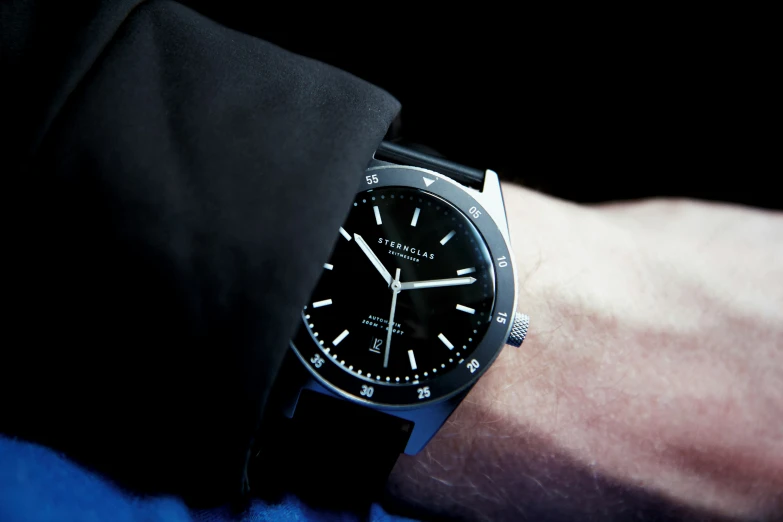 a black watch with black hands and white numbers