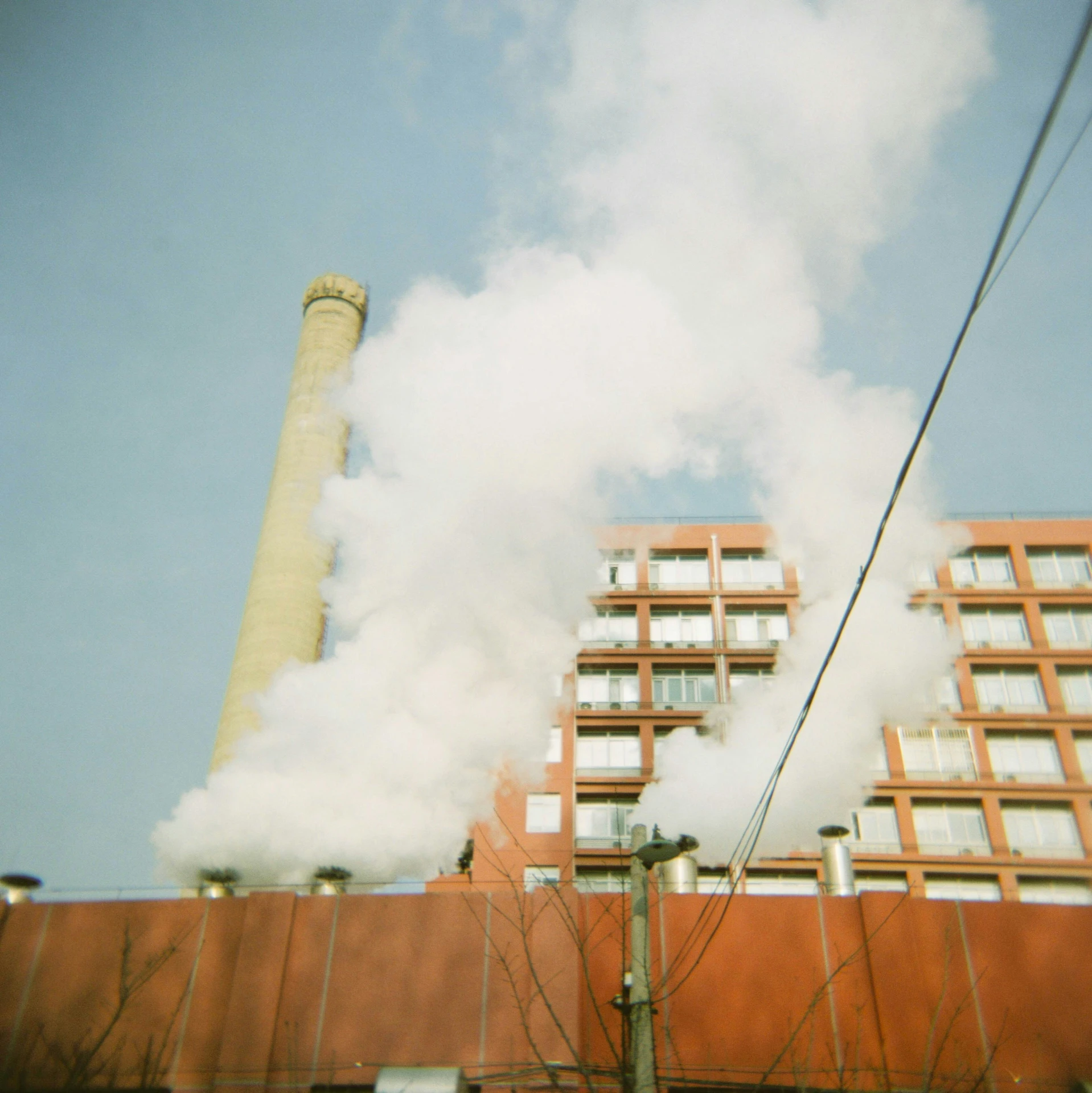 smoke stacks billowing out from a factory