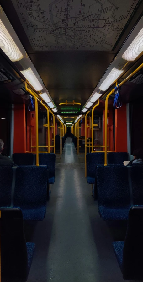 an empty train has colorful lights and blue seats