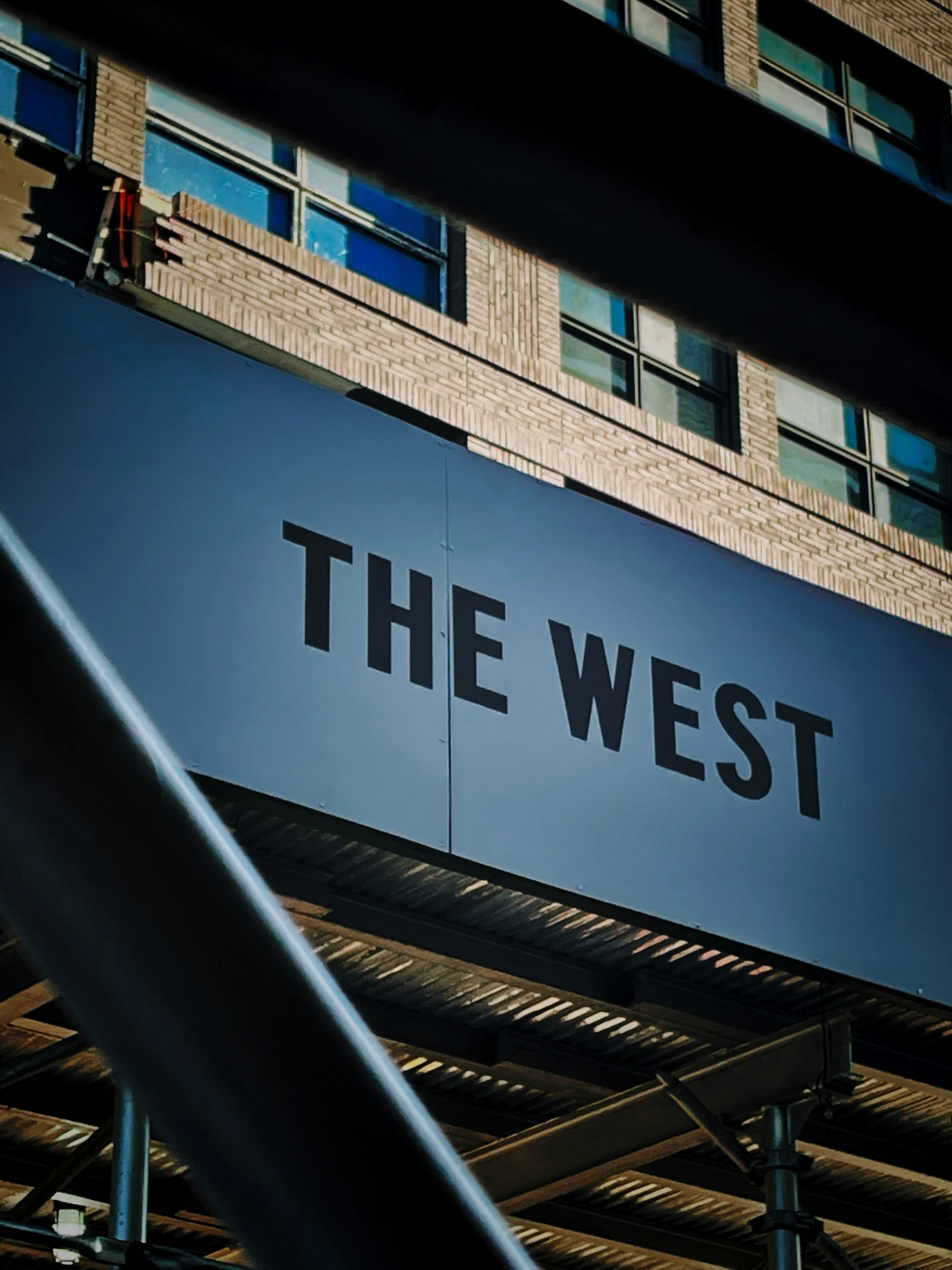 the west sign above the street under some buildings