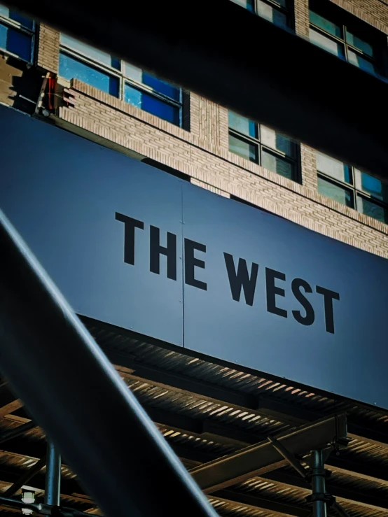 the west sign above the street under some buildings