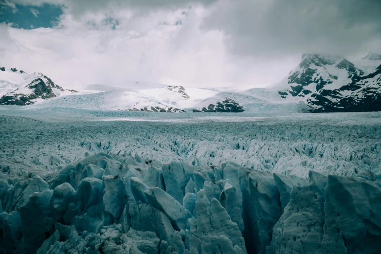 glacier waters surrounded by mountains are blue in color