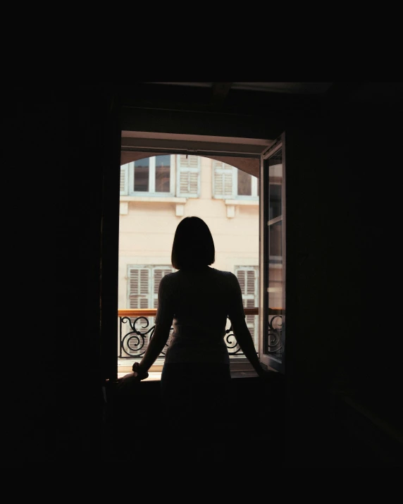 a woman standing in a doorway looking out