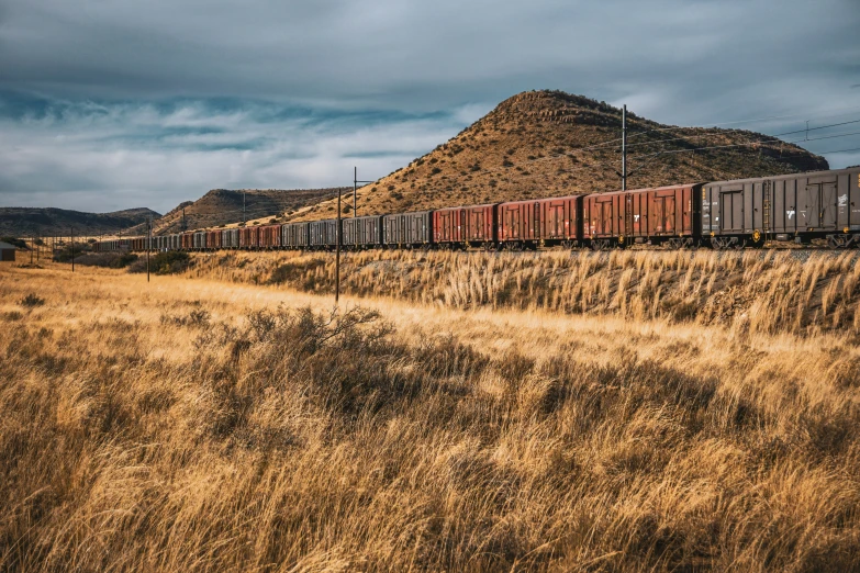 a train is rolling through the middle of a barren area