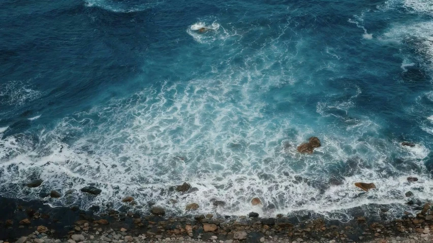 the ocean with white and blue waves breaking