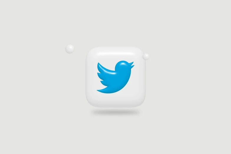 a blue twitter logo is sitting on the computer screen